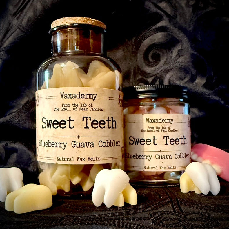 Two jars of 'Sweet Teeth' wax melts by Waxademmy on a dark background.