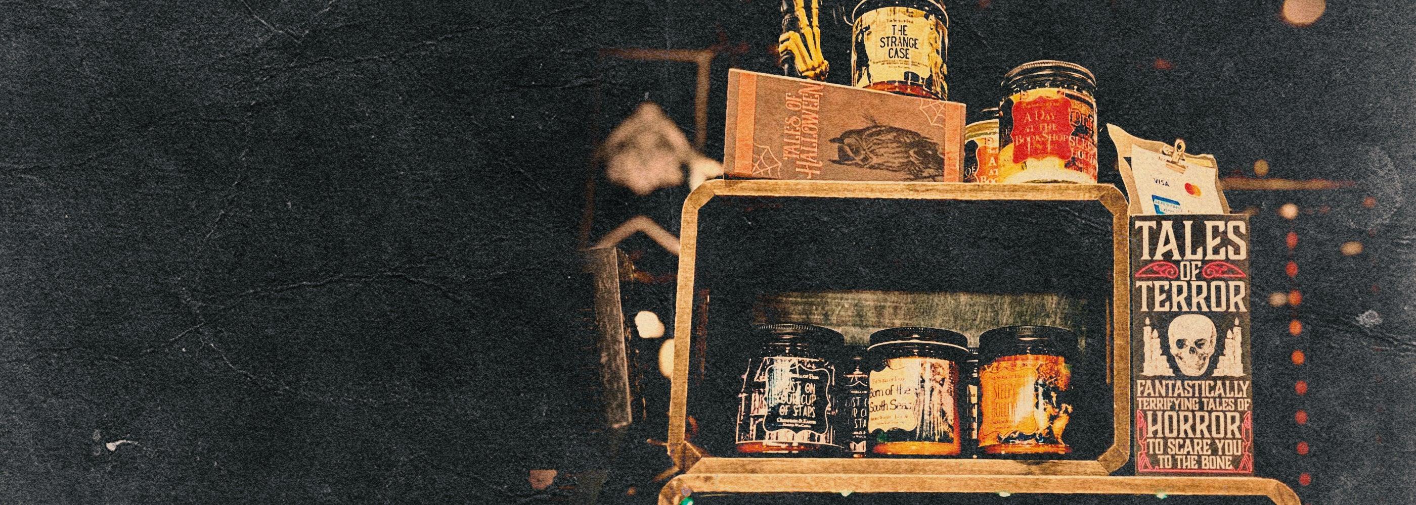Display of horror candles, spooky books, and gothic decor with Tales of Terror sign