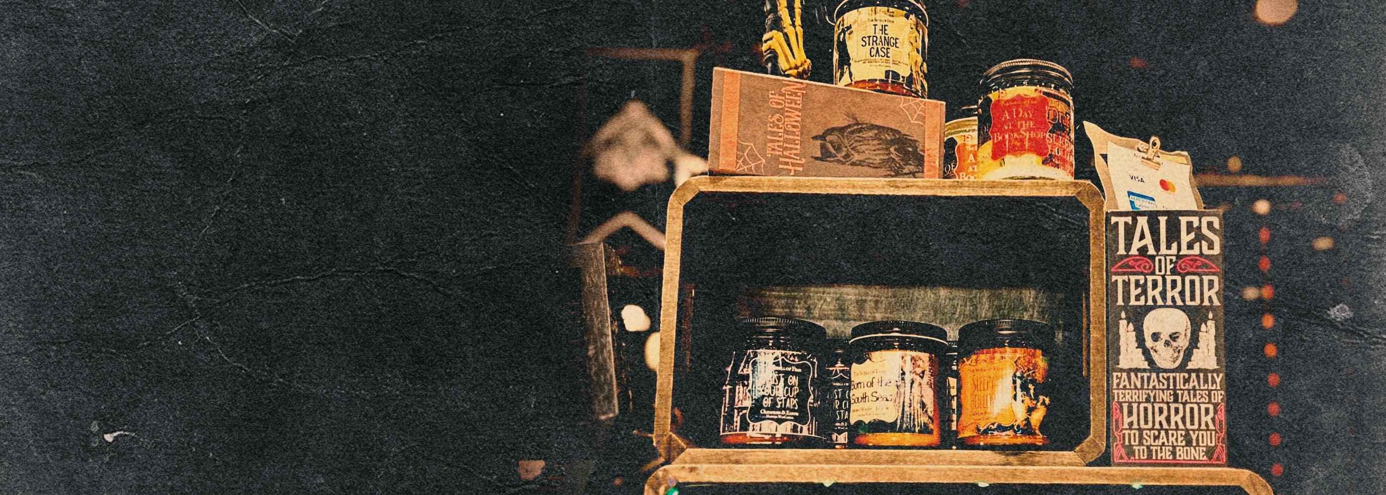 Display of horror candles, spooky books, and gothic decor with Tales of Terror sign